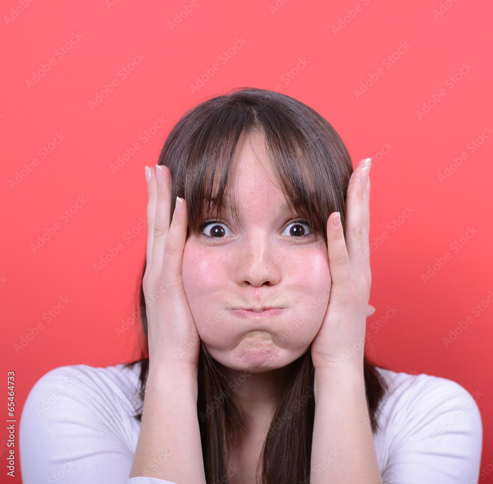 Portrait of amazed girl against red background Portrait of amazed girl against red background