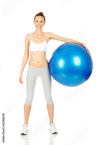 Fitness girl holding pilates ball