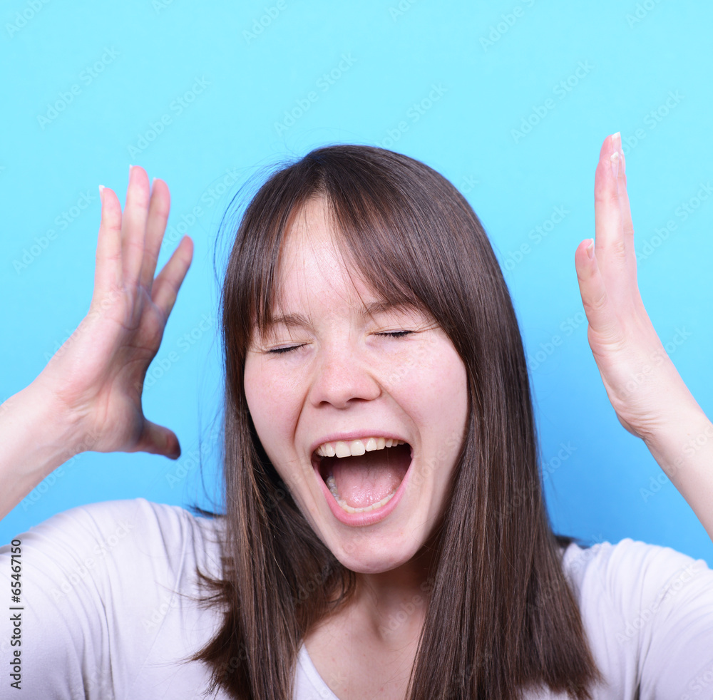 Portrait of girl screaming against blue background Portrait of girl screaming against blue background