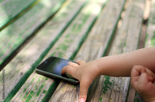 Baby girl taking the mobile phone