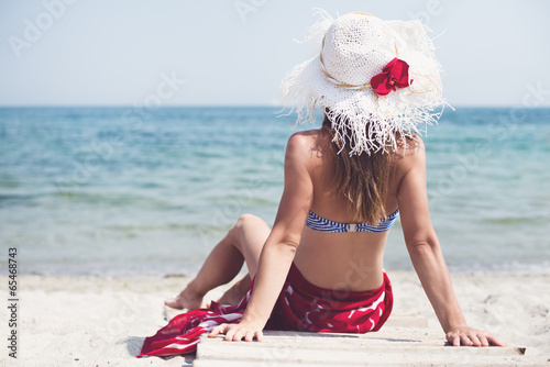 Woman sitting at the beach photo