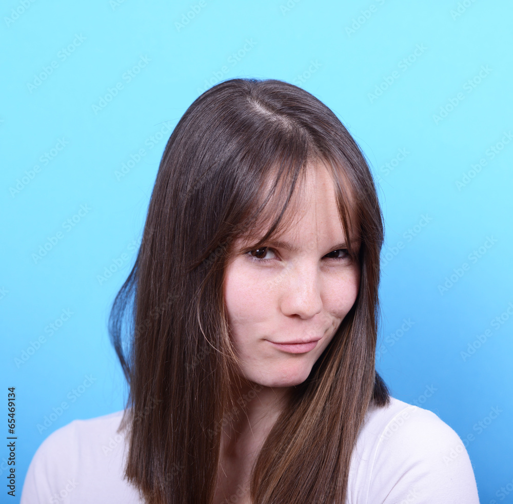 Portrait of woman with sexy look against blue background Portrait of woman with sexy look against blue background