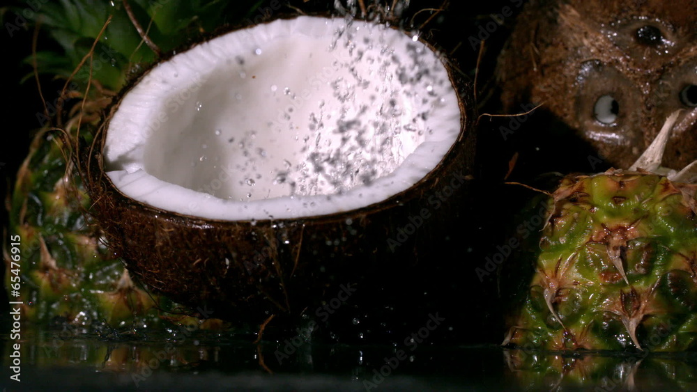 Coconut falling in front of pineapples Coconut falling in front of pineapples