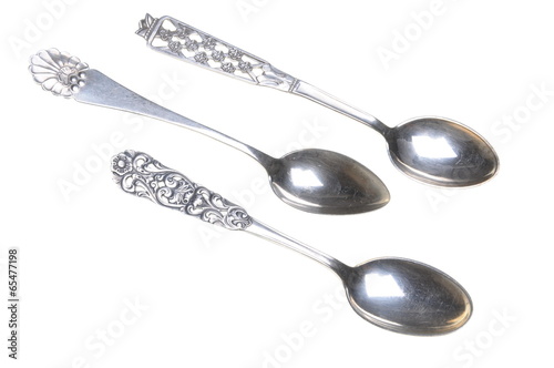 Old silver spoons isolated on white background