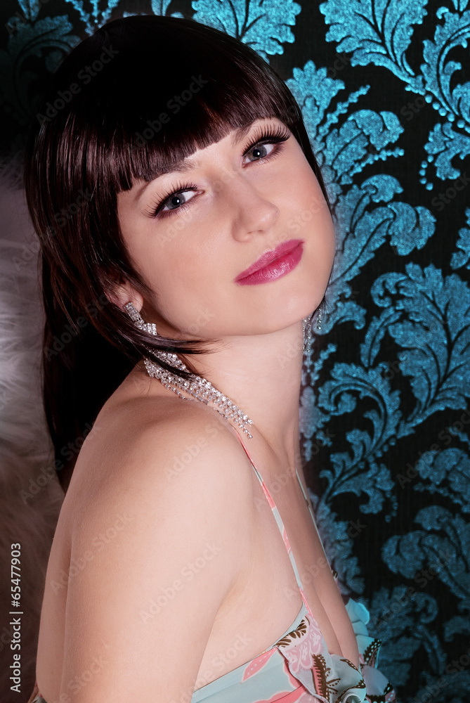 young beautiful girl brunette with bangs in the Studio