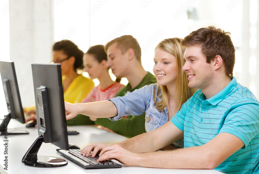smiling students in computer class at school smiling students in computer class at school
