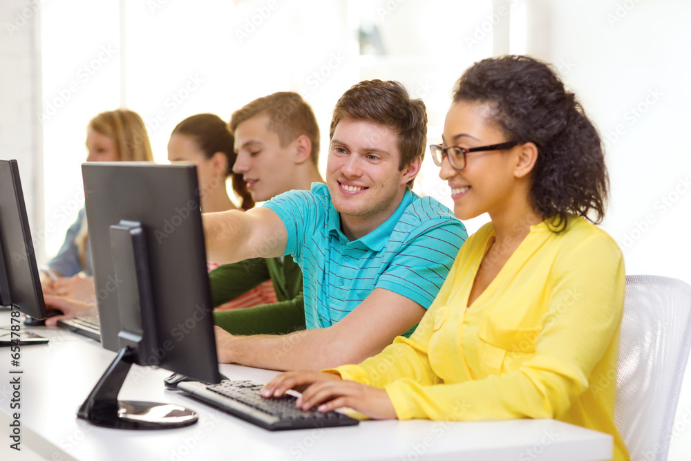 smiling students in computer class at school