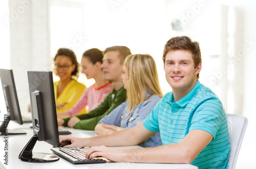 male student with classmates in computer class