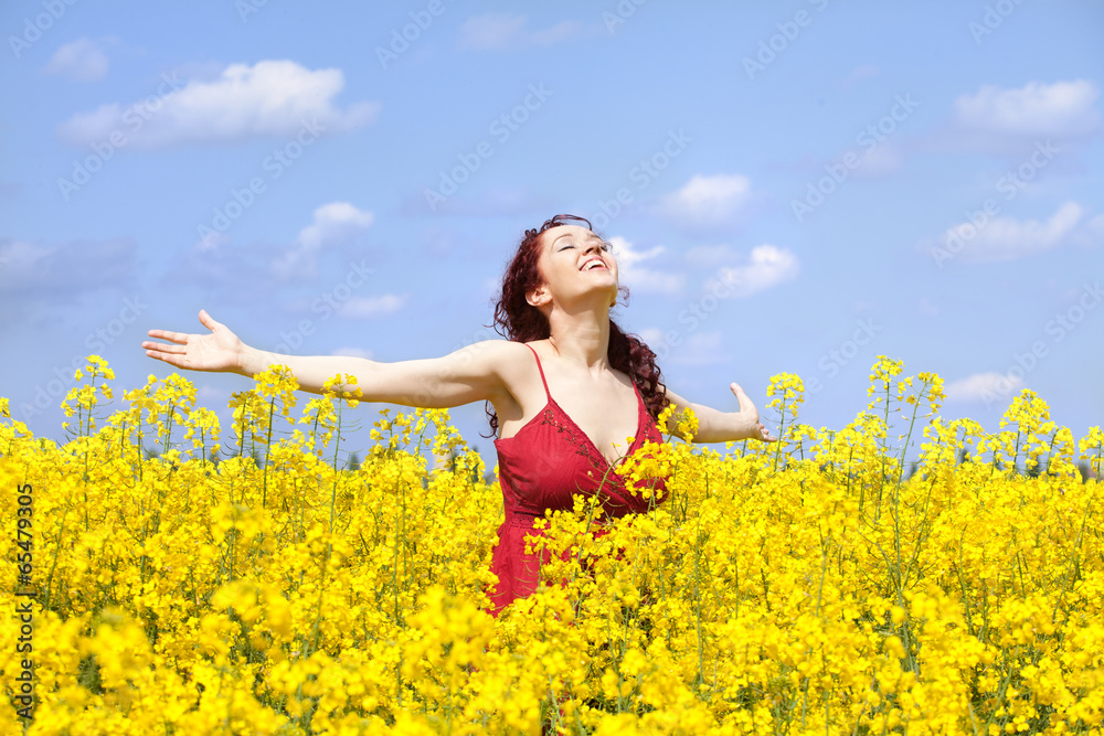 Woman enjoying in a rape field Woman enjoying in a rape field