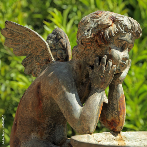 bronze sculpture of angel - detail of the fountain in garden