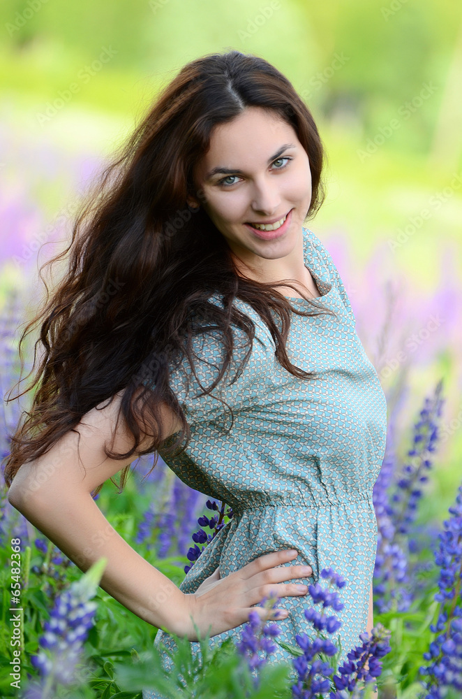 The beautiful woman in the field with lupin The beautiful woman in the field with lupin