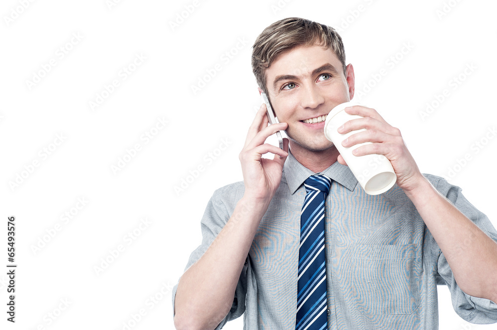 Young man using his mobile while drinking coffee Young man using his mobile while drinking coffee