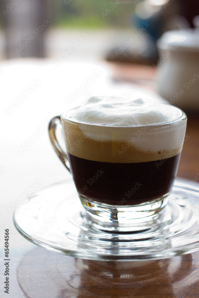 Hot espresso with milk and foam in cup. Hot espresso with milk and foam in cup.