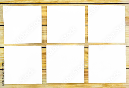 White sheets of paper on a background of wooden slats