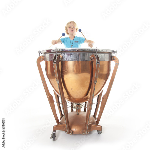 young boy playing kettledrum photo