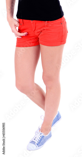 Beautiful young girl in shorts and t-shirt, close-up, isolated