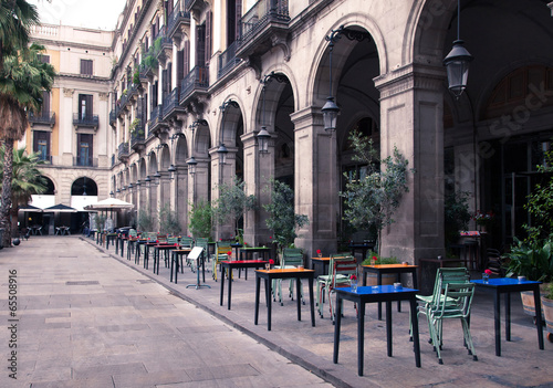 street cafe with colorful tables and chairs #65508916