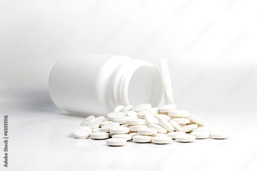 White pills out of pill bottle on white background - obrazy, fototapety, plakaty 