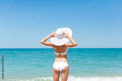Woman on beach, Rear view girl summer hat bikini