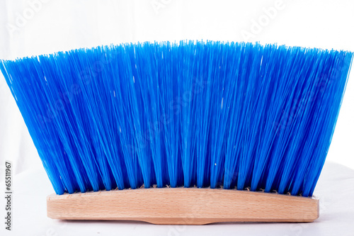 Wooden blue brush for cleaning a floor isolated on a white
