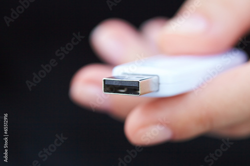 hand holding black USB data storage