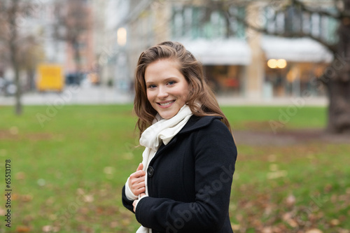 Woman In Winter Jacket And Scarf Smiling