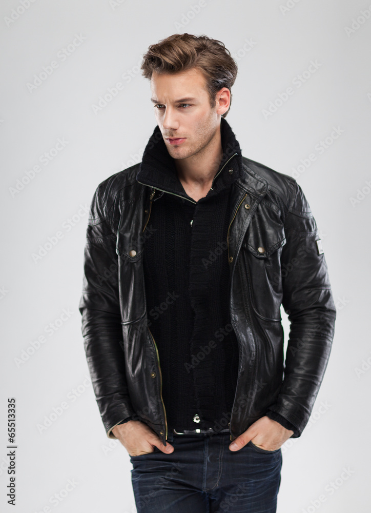 Fototapeta premium Fashion man, model leather jacket, gray background