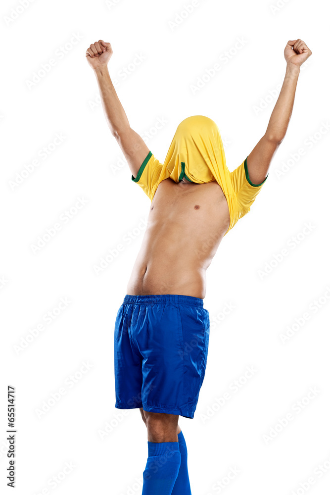 excited soccer fan with shirt over his head brazil worldcup