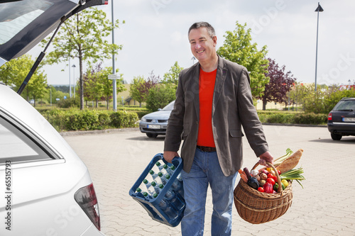 Man lifts Basket water tank in the car photo