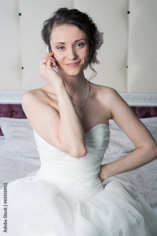 Happy smiling bride talking on the phone Happy smiling bride talking on the phone