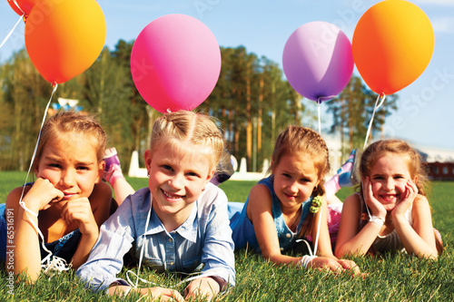 group of happy children with balloons