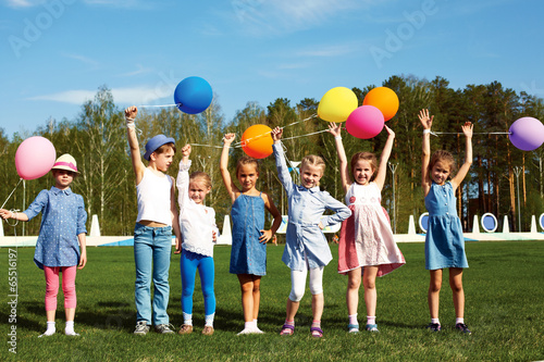 Big group of happy children with balloons