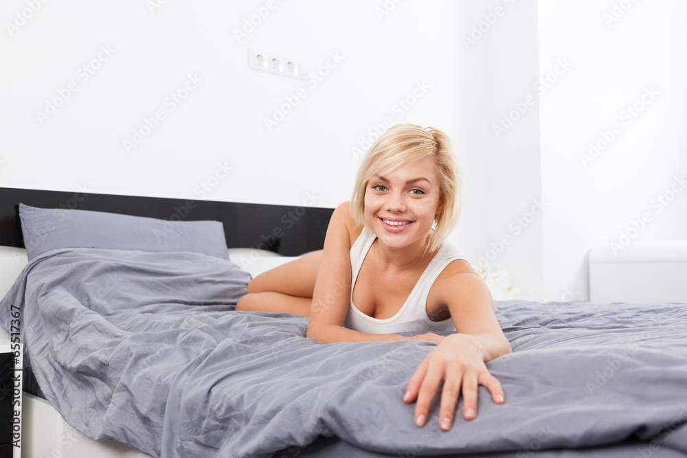 Beautiful woman lying on bed home Beautiful woman lying on bed home
