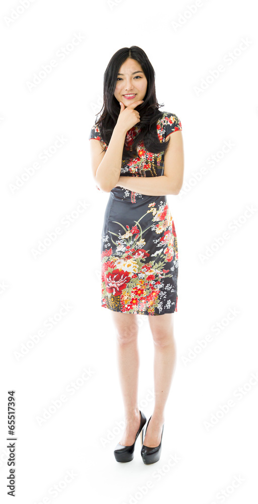 Asian young woman standing with hand on chin Asian young woman standing with hand on chin