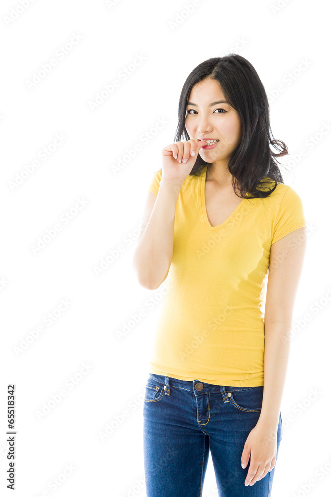 Young Asian woman smiling with finger in mouth Young Asian woman smiling with finger in mouth