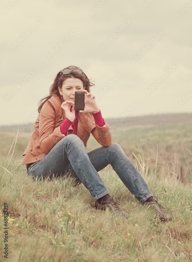 Woman using her mobile phone outdoors Woman using her mobile phone outdoors