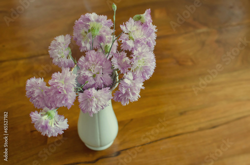 Pink flowers bouquet against a wooden background