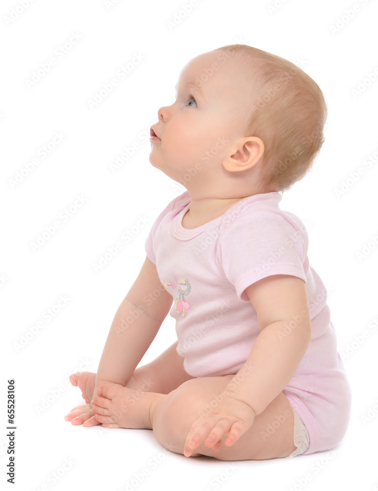 Infant child baby toddler sitting happy looking at the corner Infant child baby toddler sitting happy looking at the corner
