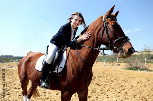 Beautiful girl riding a horse outdoors