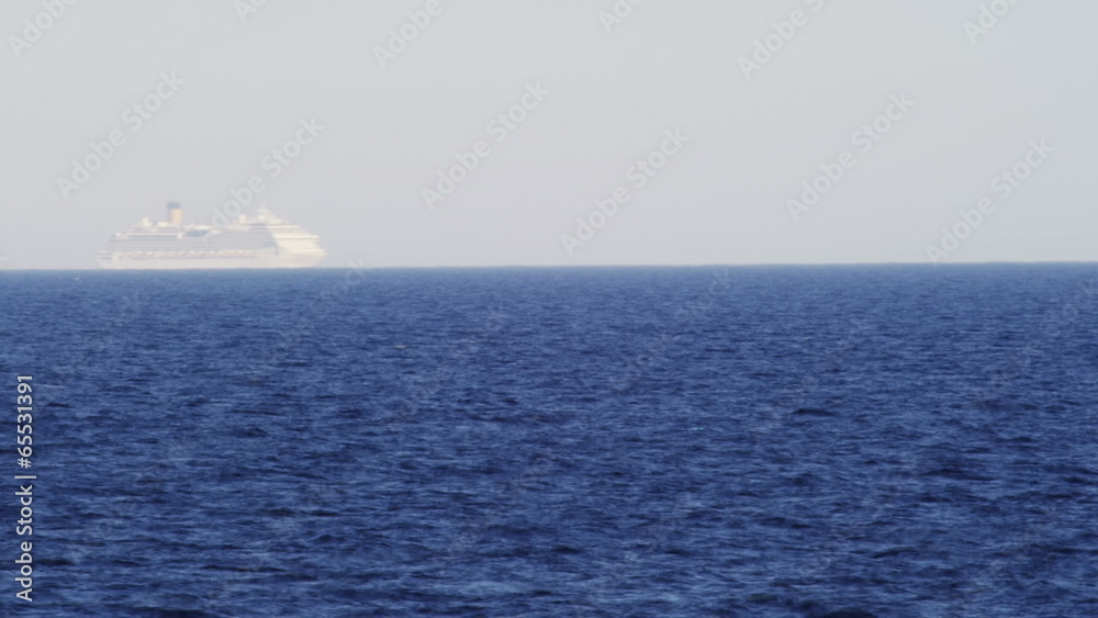 Timelapse shot - cruise ship passing by on the horizon Timelapse shot - cruise ship passing by on the horizon