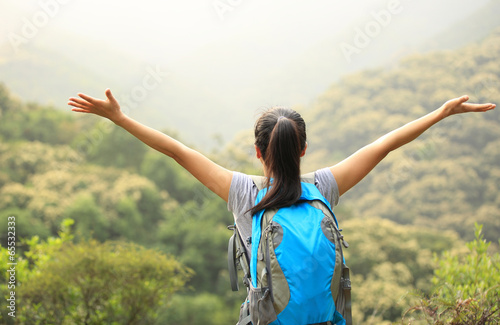 cheering hiking woman enjoy the beautiful view at mountain peak 