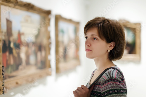  woman looking pictures in  museum photo