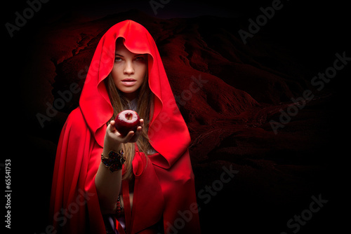 beautiful woman with red cloak holding apple