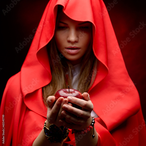 beautiful woman with red cloak holding apple
