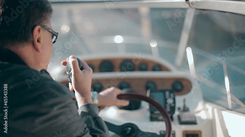 Man with radio set on the yacht
