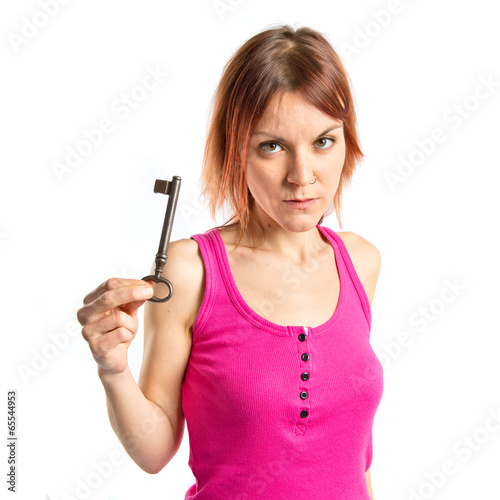 Redhead girl holding vintage key over white background