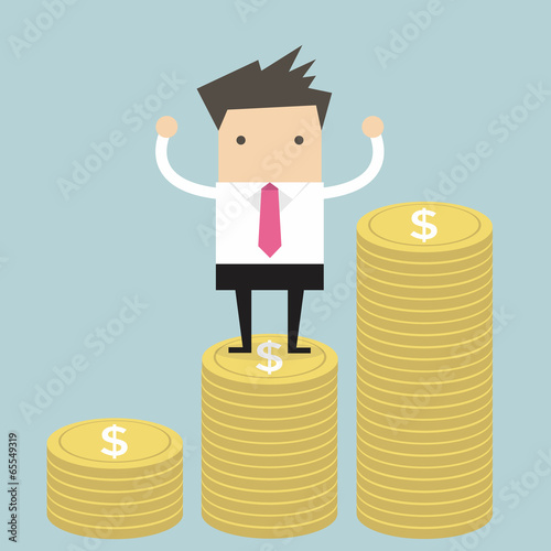 Businessman standing on gold coin