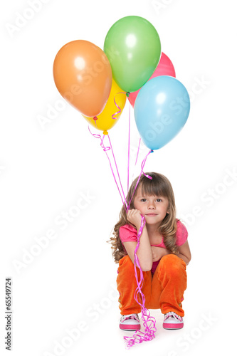 Thoughtful little girl with balloons