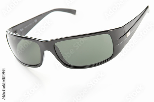 The photo shows sunglasses over white