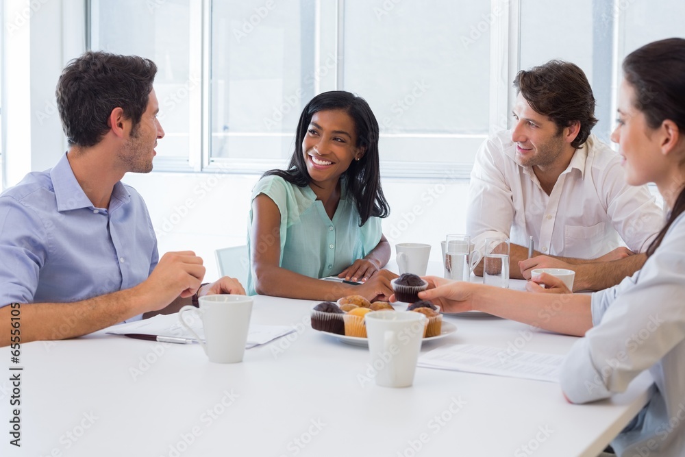 Work colleagues chatting in board room while enjoying coffee and Work colleagues chatting in board room while enjoying coffee and